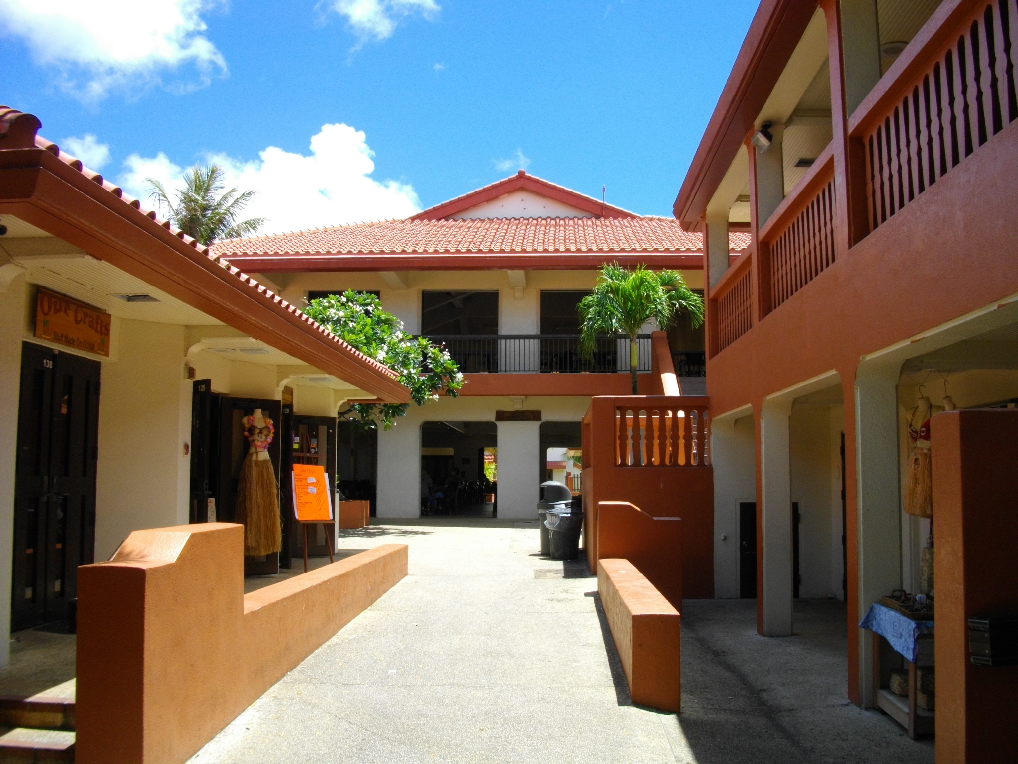 Open-air walkways and red-roofed buildings at Chamorro Village in Guam